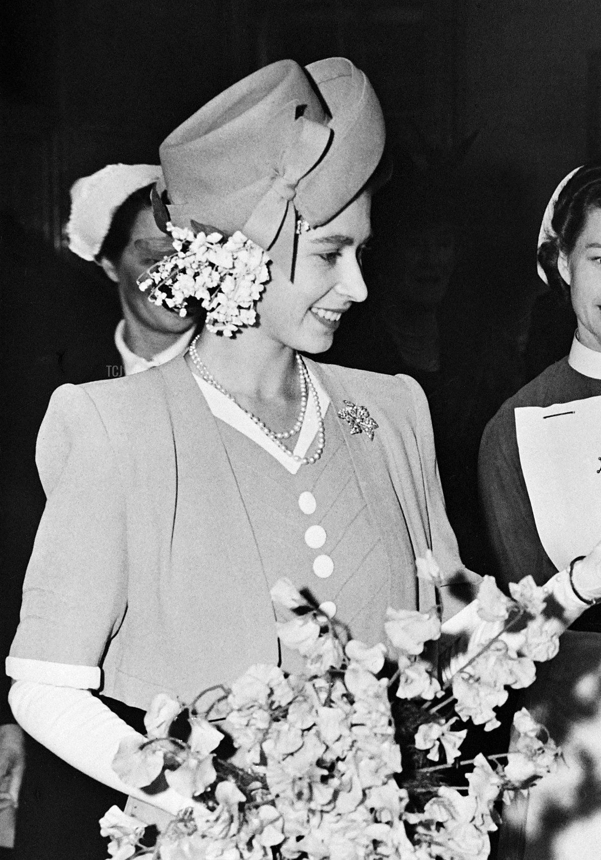 Princess Elizabeth reaches out to a little girl in May 1947