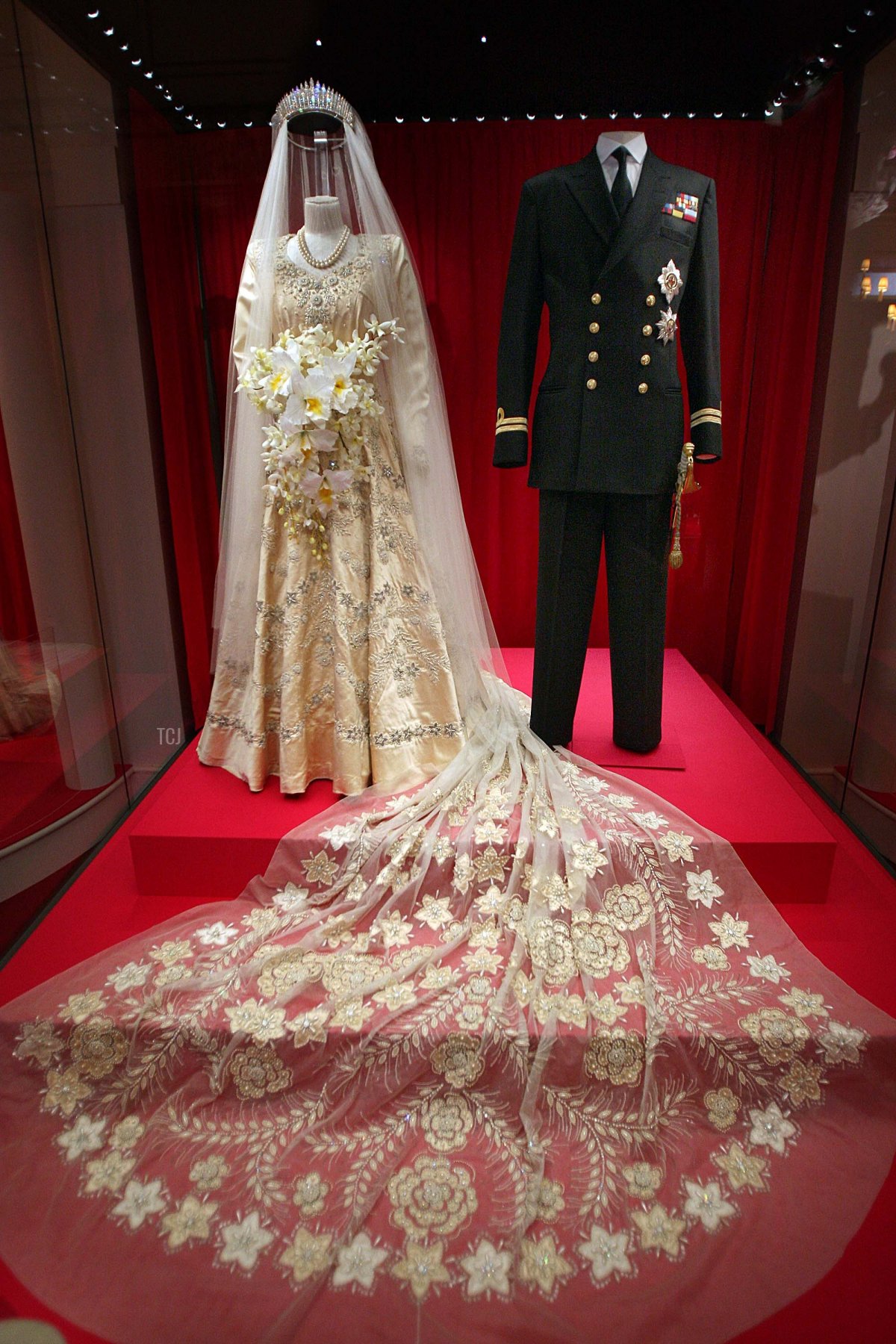 Princess Elizabeth's wedding dress, designed by Norman Hartnell, and the Duke of Edinburgh's Royal Naval uniform are displayed at the 'Royal Wedding: 20 Novermber 1957' exhibition at Buckingham Palace on July 27, 2007 in London