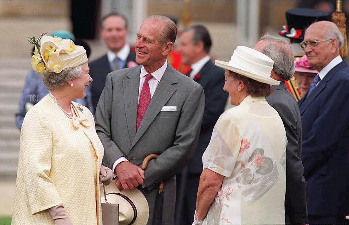 Britain's Queen Elizabeth II and her husband the Duke of Edinburgh (C) meet guests, all couples celebrating 50 years of marriage, at the special Golden Wedding Anniversary Buckingham Palace garden party, 15 July 1997