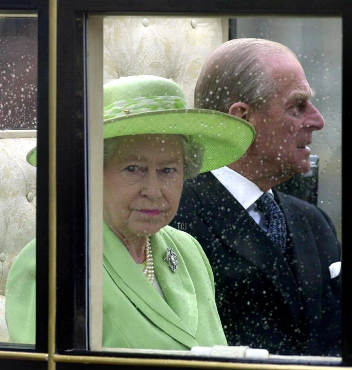 Britain's Queen Elizabeth II (L) and the Duke of Edinburgh leave Holyrood Palace on their way up the Royal Mile by the horse-drawn "Scottish State Coach" to the opening of the General Assembly of the Church of Scotland in Edinburgh 25 May 2002, as part of the continuing Golden Jubilee celebrations