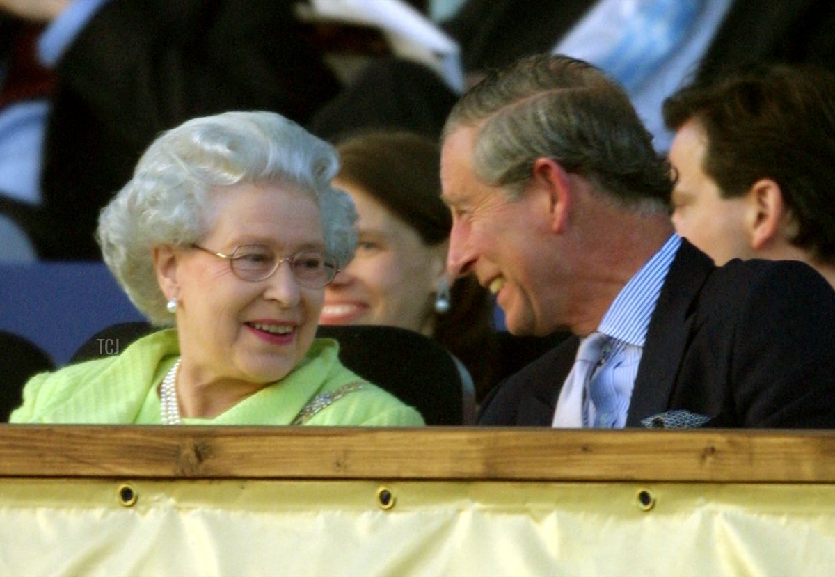 Britain's Queen Elizabeth II talks with Charles, Prince of Wales, during the "Prom At The Palace" concert on the grounds of Buckingham Palace 01 June 2002 in London, as part of the Golden Jubilee celebrating the queen's 50 years on the throne