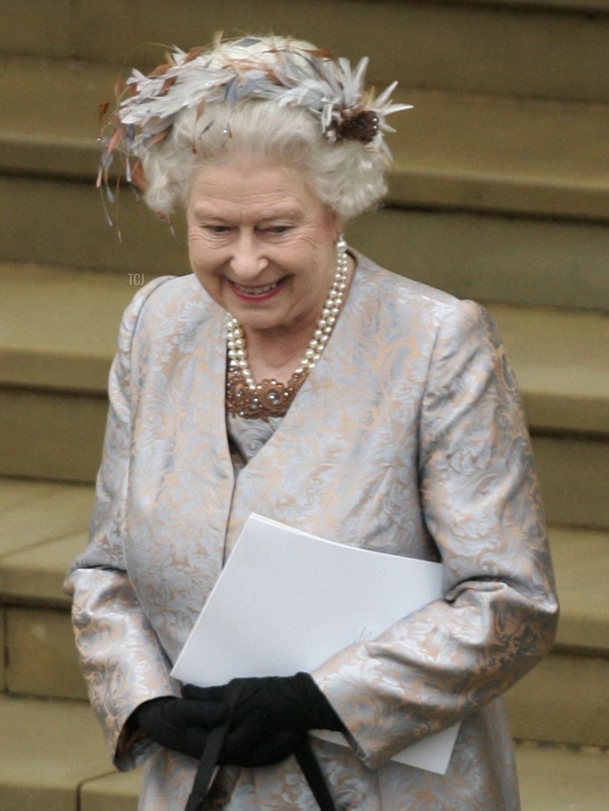 Britain's Queen Elizabeth II, (L) and Prince Philip, Duke of Edinburgh smile as they watch their grandson Peter Phillips and Canadian Autumn Kelly leave St George's Chapel in Windsor, England, after their marriage ceremony, on May 17, 2008