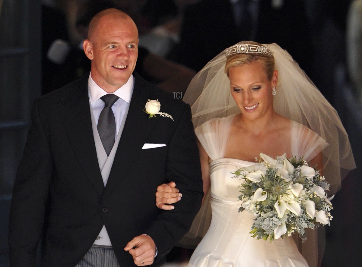 England rugby player Mike Tindall (L) and his new wife Britain's Zara Phillips, granddaughter of Queen Elizabeth II, leave after their wedding ceremony at Canongate Kirk in Edinburgh, Scotland, on July 30, 2011