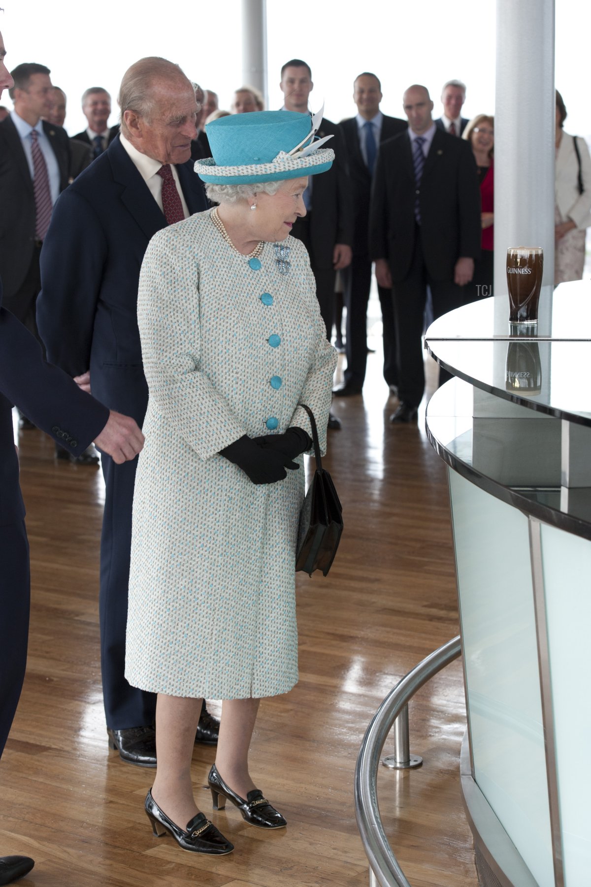 Queen Elizabeth II (R) and Prince Philip, Duke of Edinburgh watch a pint of Guinness being poured as they visit the Guinness Storehouse on May 18, 2011 in Dublin, Ireland