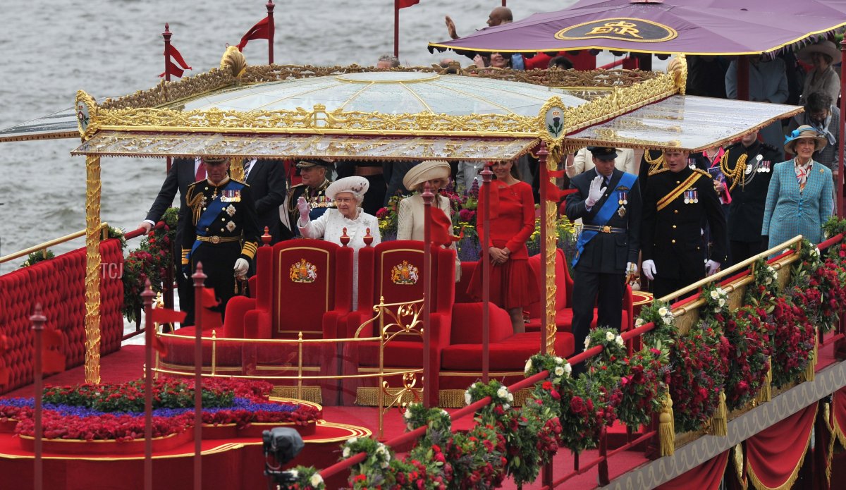 Britain's Queen Elizabeth II (C) waves from the royal barge 'Spirit of Chartwell' with other members of the royal family (L-R) Prince Charles, Prince of Wales, Prince Philip, Duke of Edinburgh, Camilla, Duchess of Cornwall, Catherine, Duchess of Cambridge, Prince William and Prince Harry during the Thames Diamond Jubilee Pageant on the River Thames in London on June 3, 2012