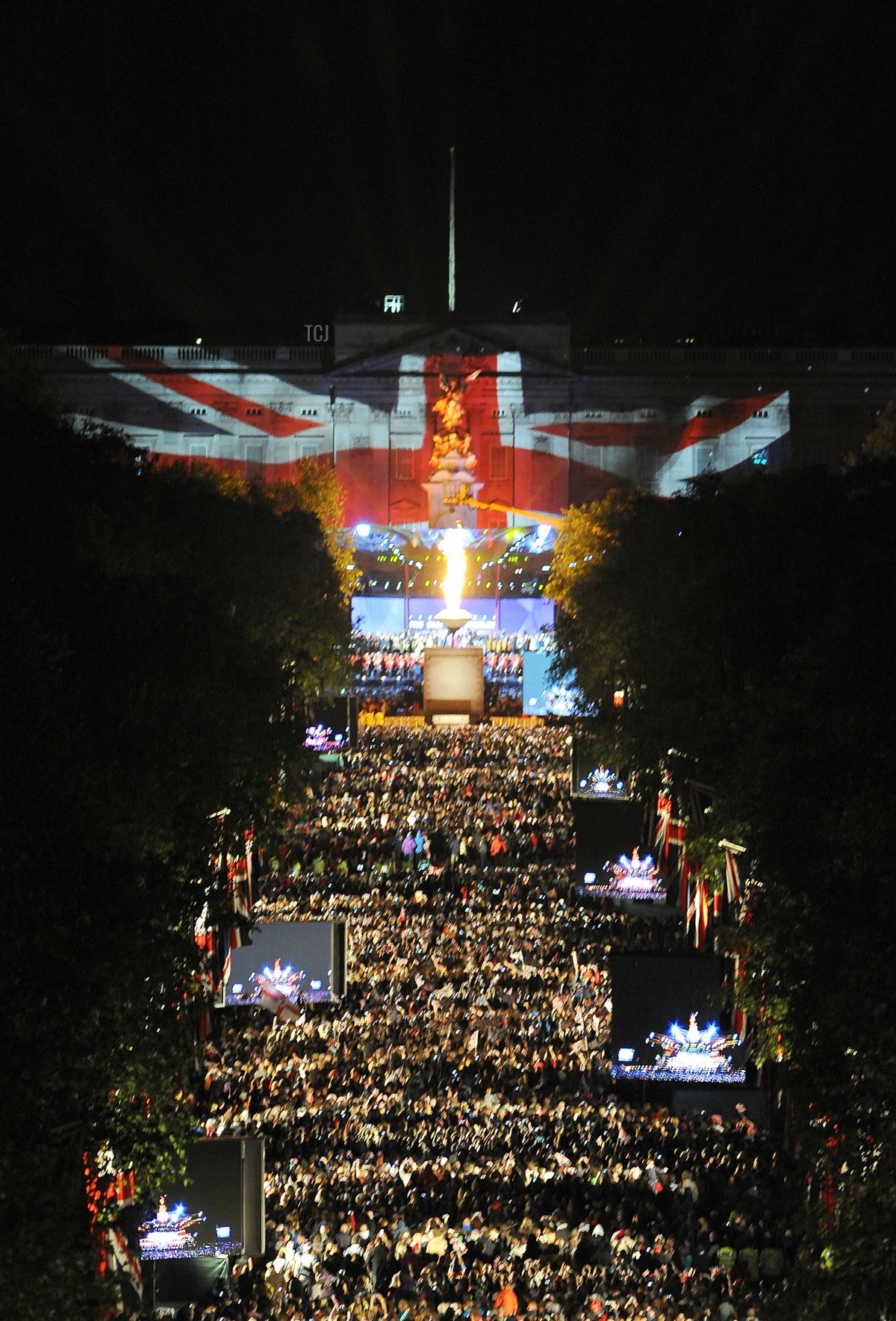 A beacon (C) is lit by Queen Elizabeth II amid a fireworks display outside Buckingham Palace in London, on June 4, 2012, to mark the end of the Diamond Jubilee Concert