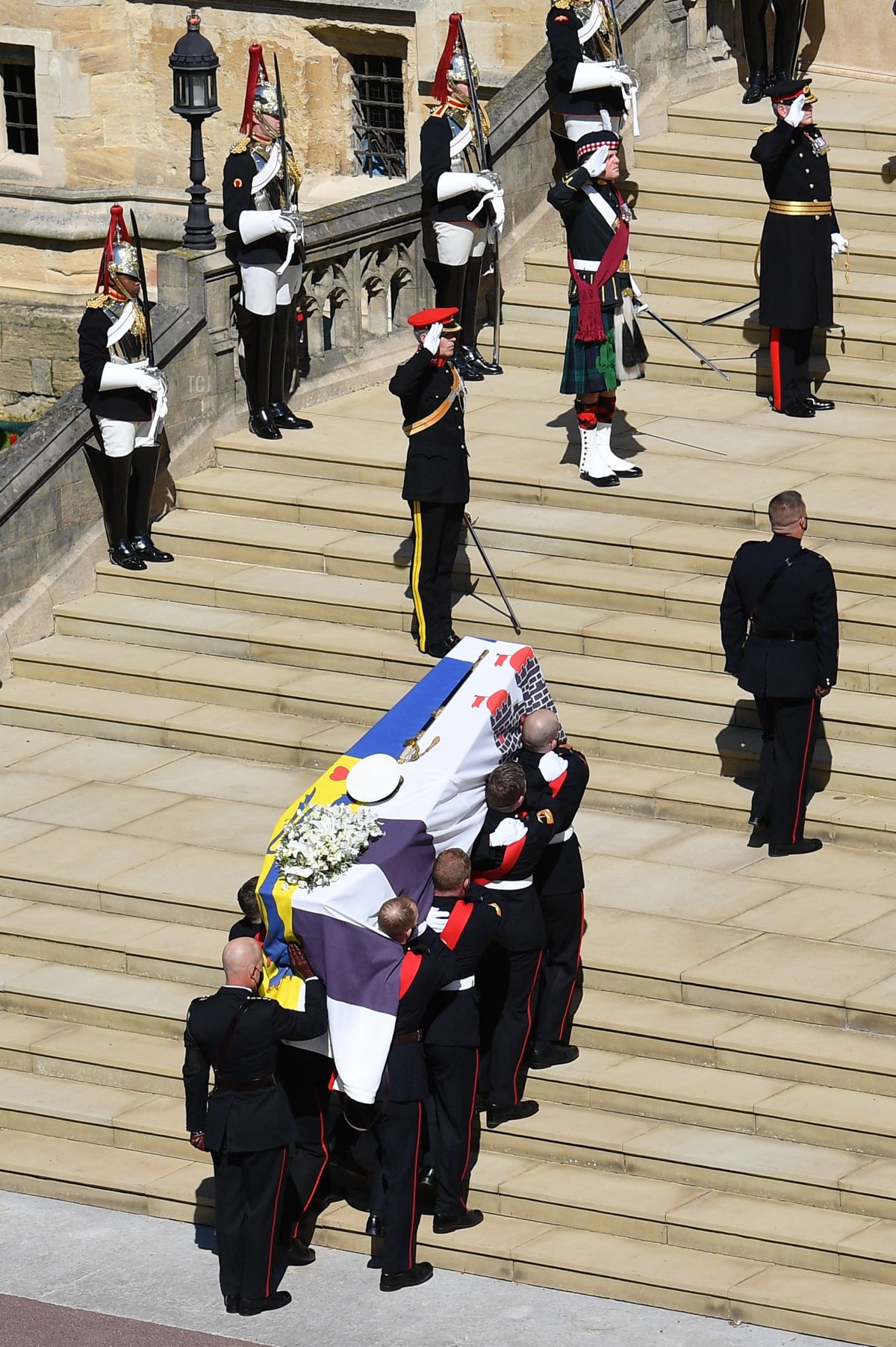 Pallbearers of the Royal Marines carry the coffin into St George's Chapel to mark the start of the funeral service of Britain's Prince Philip, Duke of Edinburgh in Windsor Castle in Windsor, west of London, on April 17, 2021