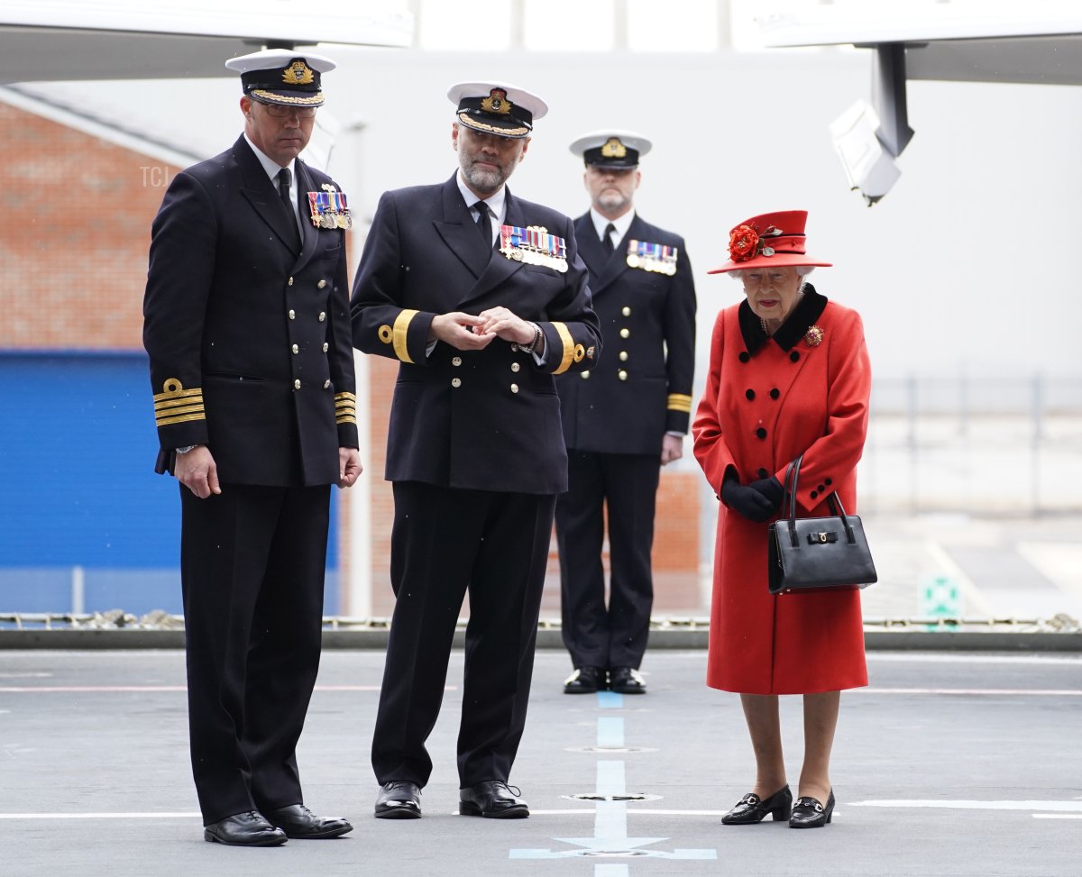 Queen Elizabeth II meeting personnel during a visit to HMS Queen Elizabeth at HM Naval Base during a visit to HMS Queen Elizabeth at HM Naval Base ahead of the ship's maiden deployment on May 22, 2021 in Portsmouth, England