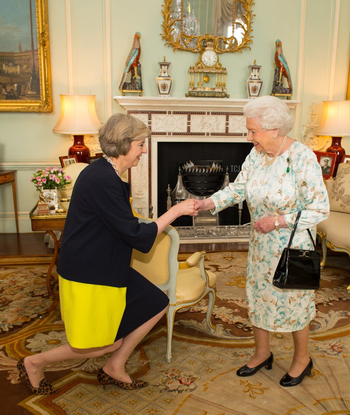 Queen Elizabeth II welcomes Theresa May at the start of an audience where she invited the former Home Secretary to become Prime Minister and form a new government at Buckingham Palace on July 13, 2016 in London, England