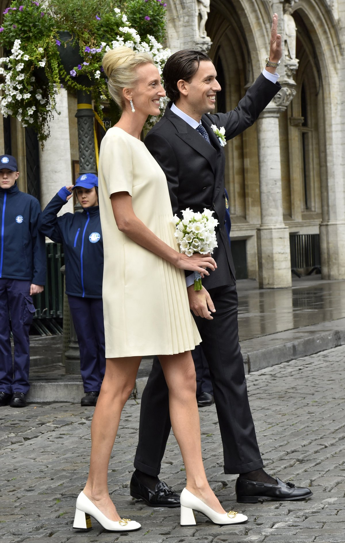 Princess Maria-Laura of Belgium (L) and William Isvy wave as they leave their official wedding at the Brussels City Hall in Brussels on September 10, 2022