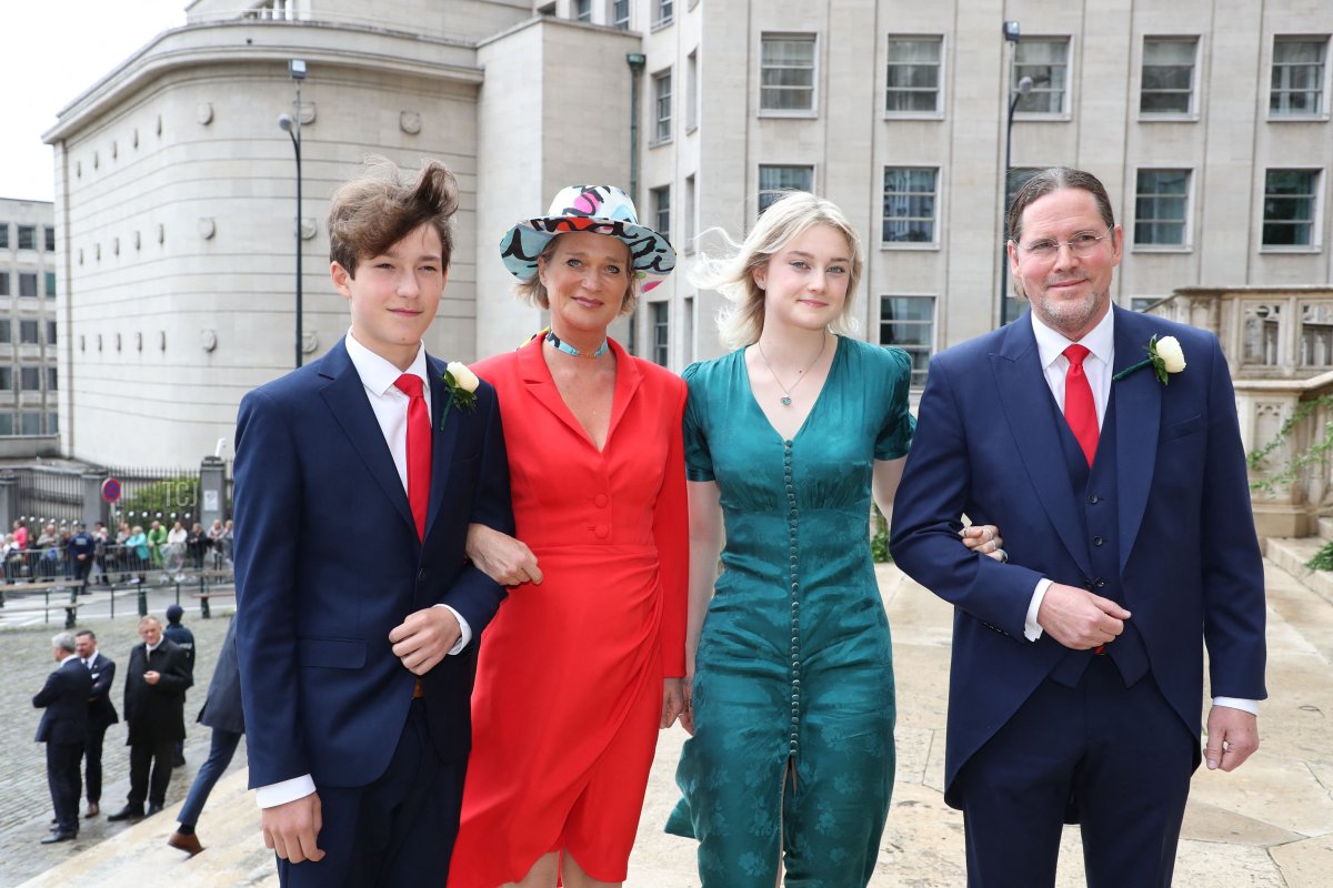 Princess Delphine (2ndL), poses with her husband Jim O'Hare (R) and their children Oscar and Josephine for a photo while arriving to the wedding ceremony of Princess Maria-Laura of Belgium and William Isvy, at Saint Michael and Saint Gudula Cathedral in Brussels on September 10, 2022