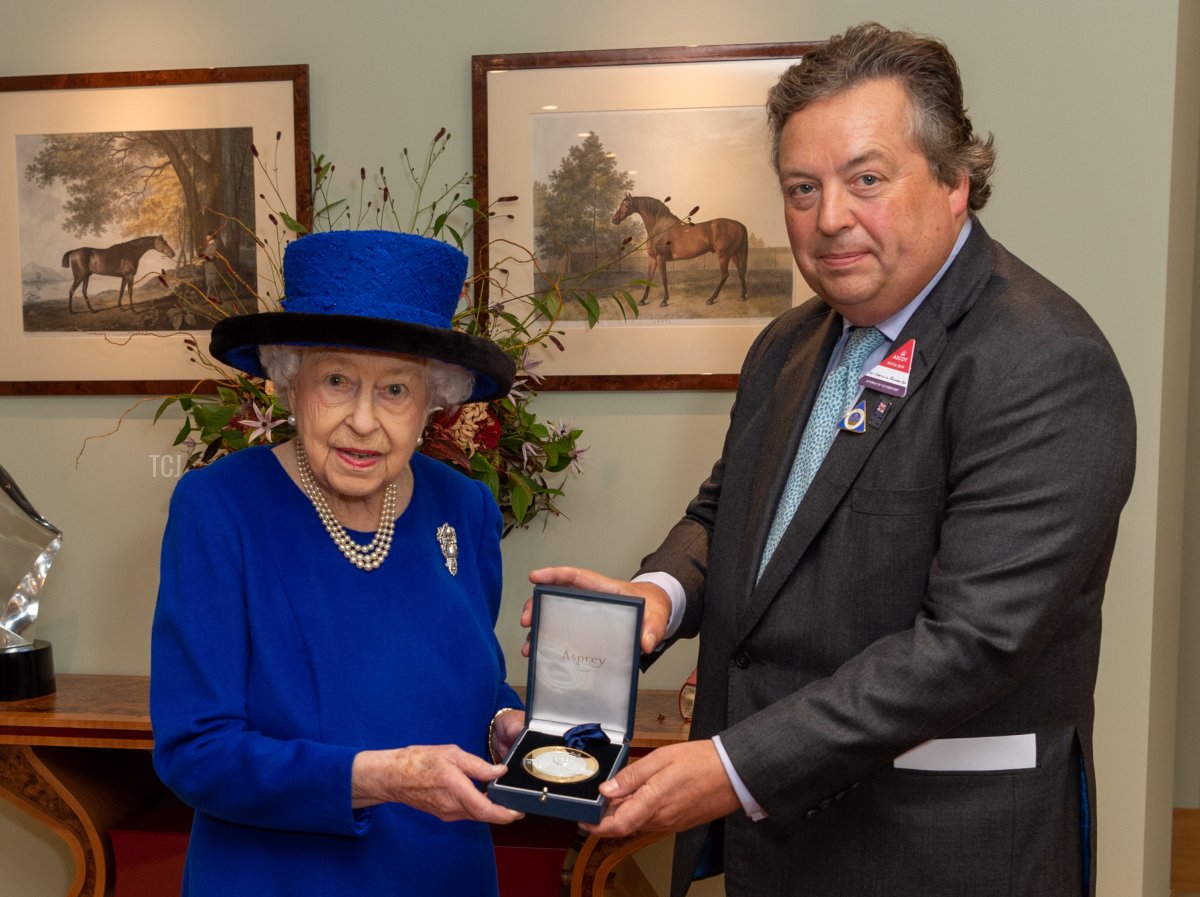 Queen Elizabeth II receives a special memento from Her Majestys Representative at Ascot, Sir Francis Brooke Bt., to mark her induction into the British Champions Series Hall of Fame, the official Hall of Fame for British Flat racing, on October 16, 2021 in Ascot, England