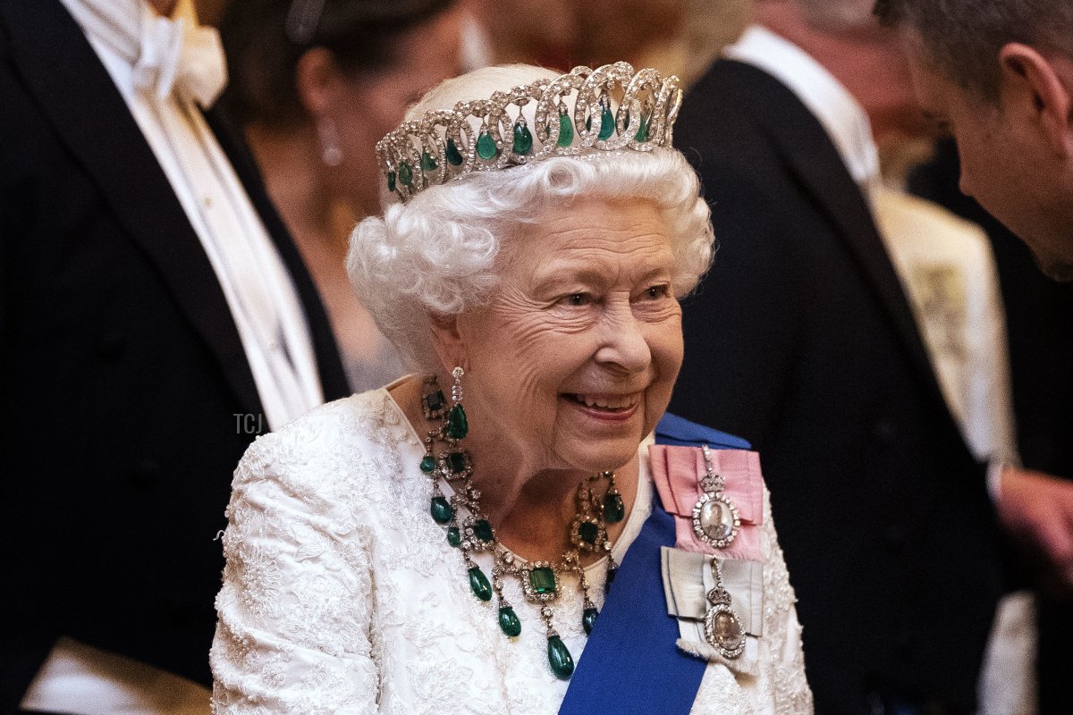 Queen Elizabeth II talks to guests at an evening reception for members of the Diplomatic Corps at Buckingham Palace on December 11, 2019 in London, England