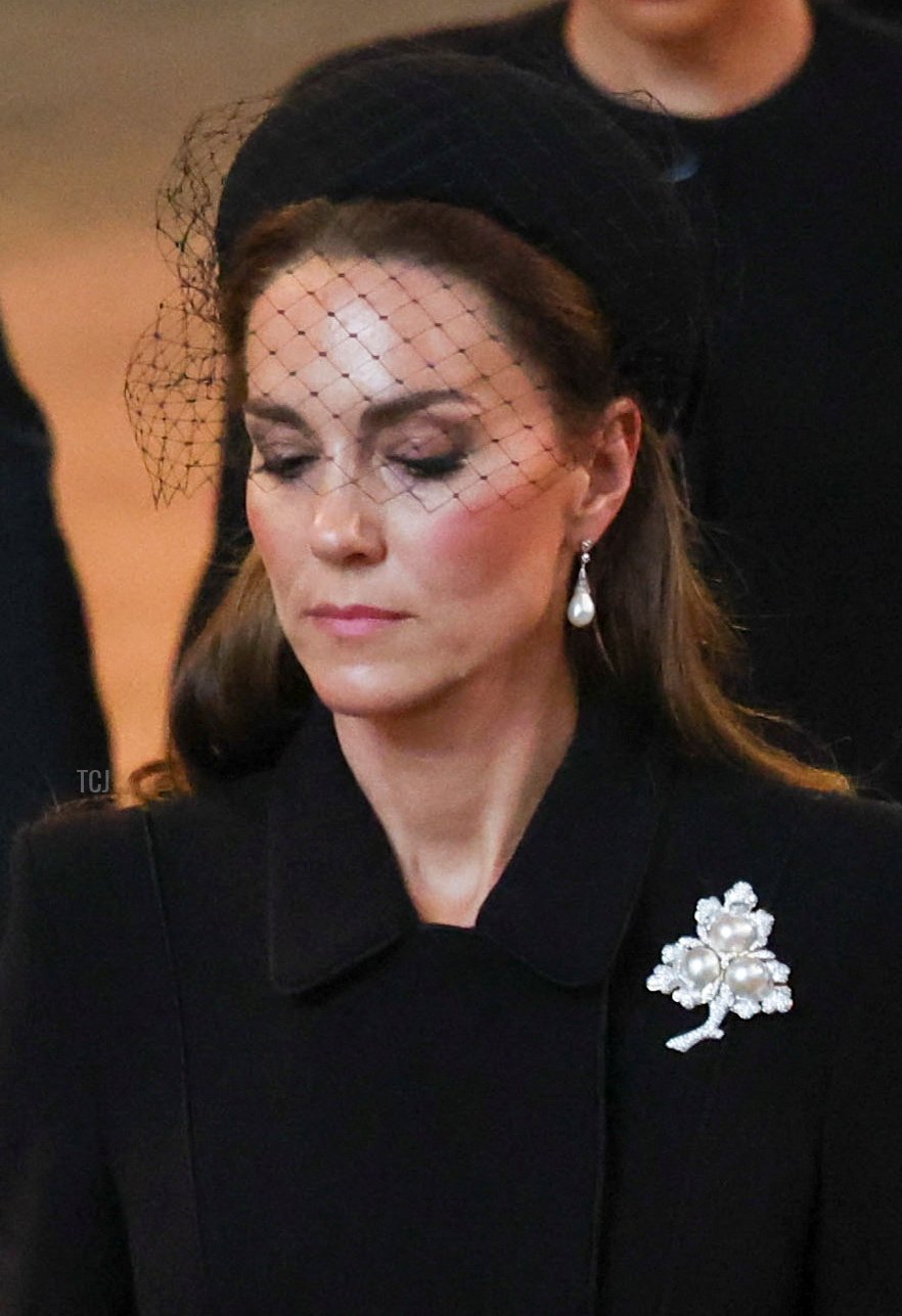 Britain's Catherine, Princess of Wales and Meghan, Duchess of Sussex walk as procession with the coffin of Britain's Queen Elizabeth arrives at Westminster Hall from Buckingham Palace for her lying in state, on September 14, 2022 in London, England