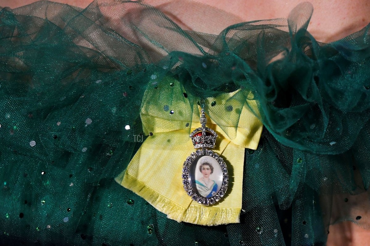 A detail view of Catherine, Duchess of Cambridge's brooch featuring a portrait of the Queen during a dinner hosted by the Governor General of Jamaica at King's House on March 23, 2022 in Kingston, Jamaica