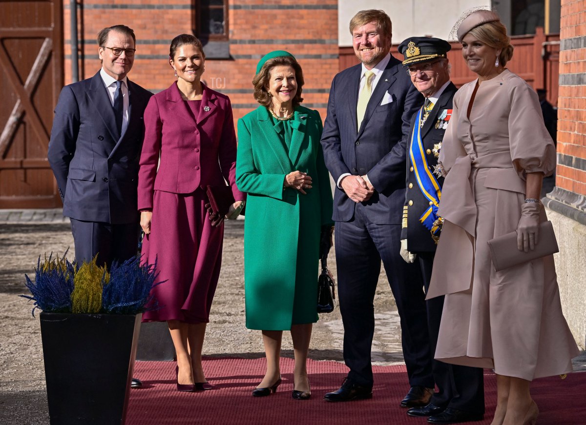 Prince Daniel, Crown Princess Victoria, Queen Silvia and King Carl Gustaf of Sweden (2nd R) together with King Willem-Alexander of the Netherlands (3rd R) and Queen Maxima of the Netherlands (R) pose for a group photo at the Royal Court Stables prior to the horse carriage procession to the Royal Palace, in Stockholm on October 11, 2022