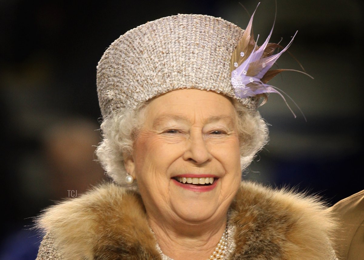 Queen Elizabeth II laughs after throwing in the puck to start an ice hockey match between Aqua City Poprad and Guildford Flames at the ice hockey stadium on the second day of a tour of Slovakia on October 24, 2008 in Bratislava, Slovakia