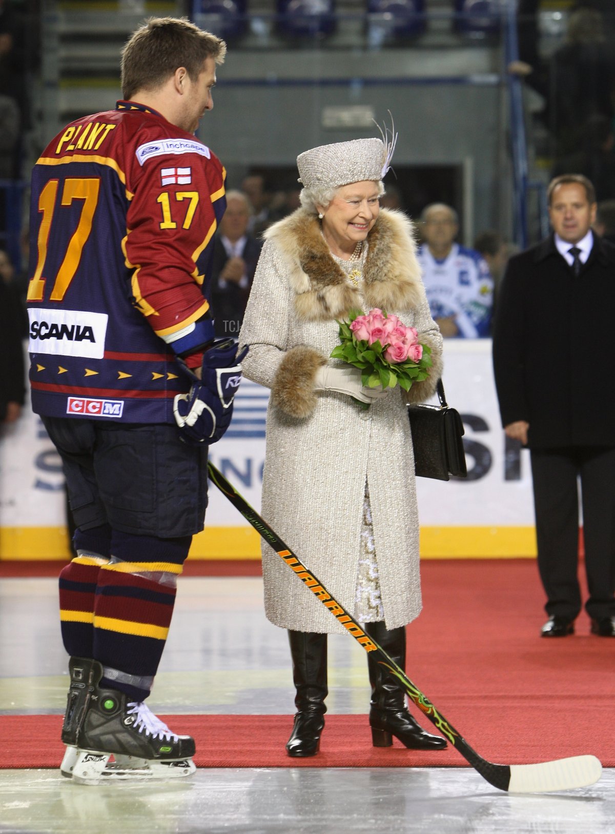 Queen Elizabeth II laughs as she chats to a player before an ice hockey match between Aqua City Poprad and Guildford Flames at the ice hockey stadium on the second day of a tour of Slovakia on October 24, 2008 in Bratislava, Slovakia