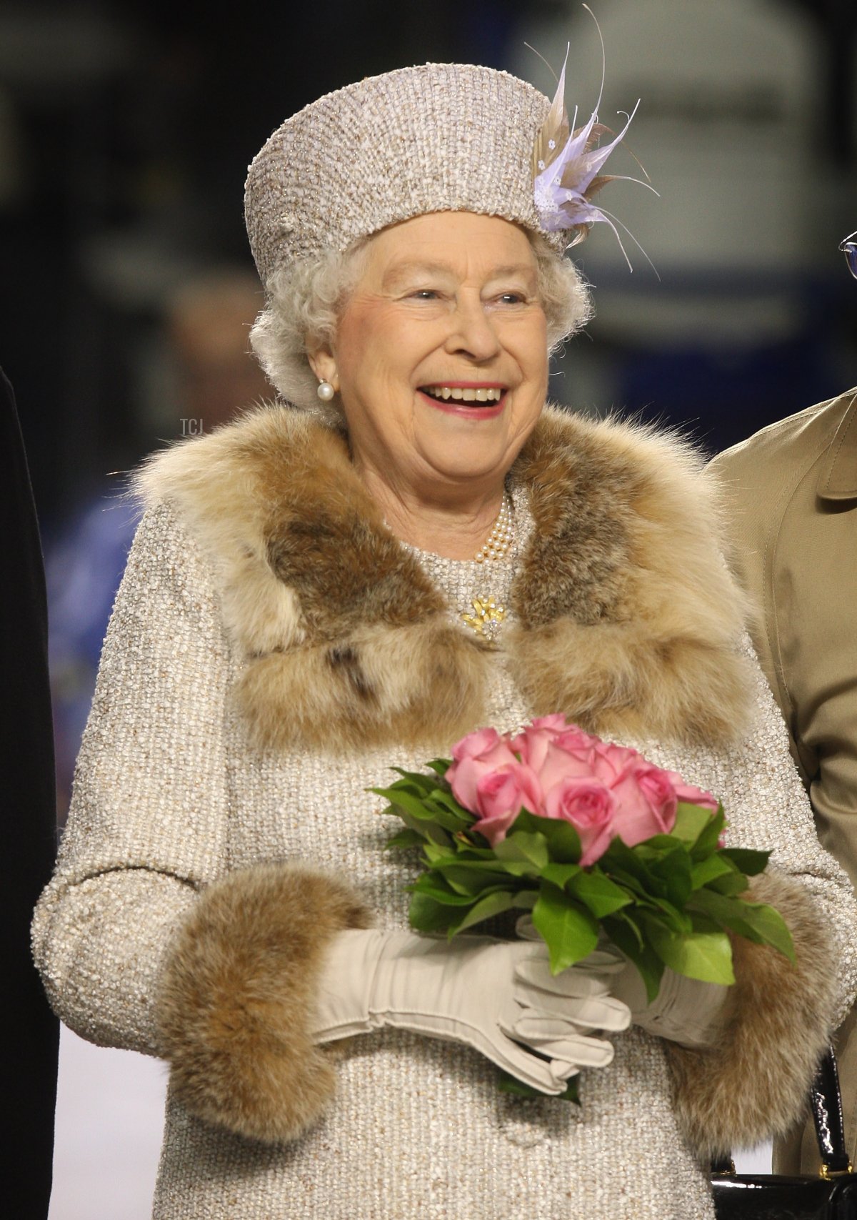 Queen Elizabeth II laughs after throwing in the puck to start an ice hockey match between Aqua City Poprad and Guildford Flames at the ice hockey stadium on the second day of a tour of Slovakia on October 24, 2008 in Bratislava, Slovakia