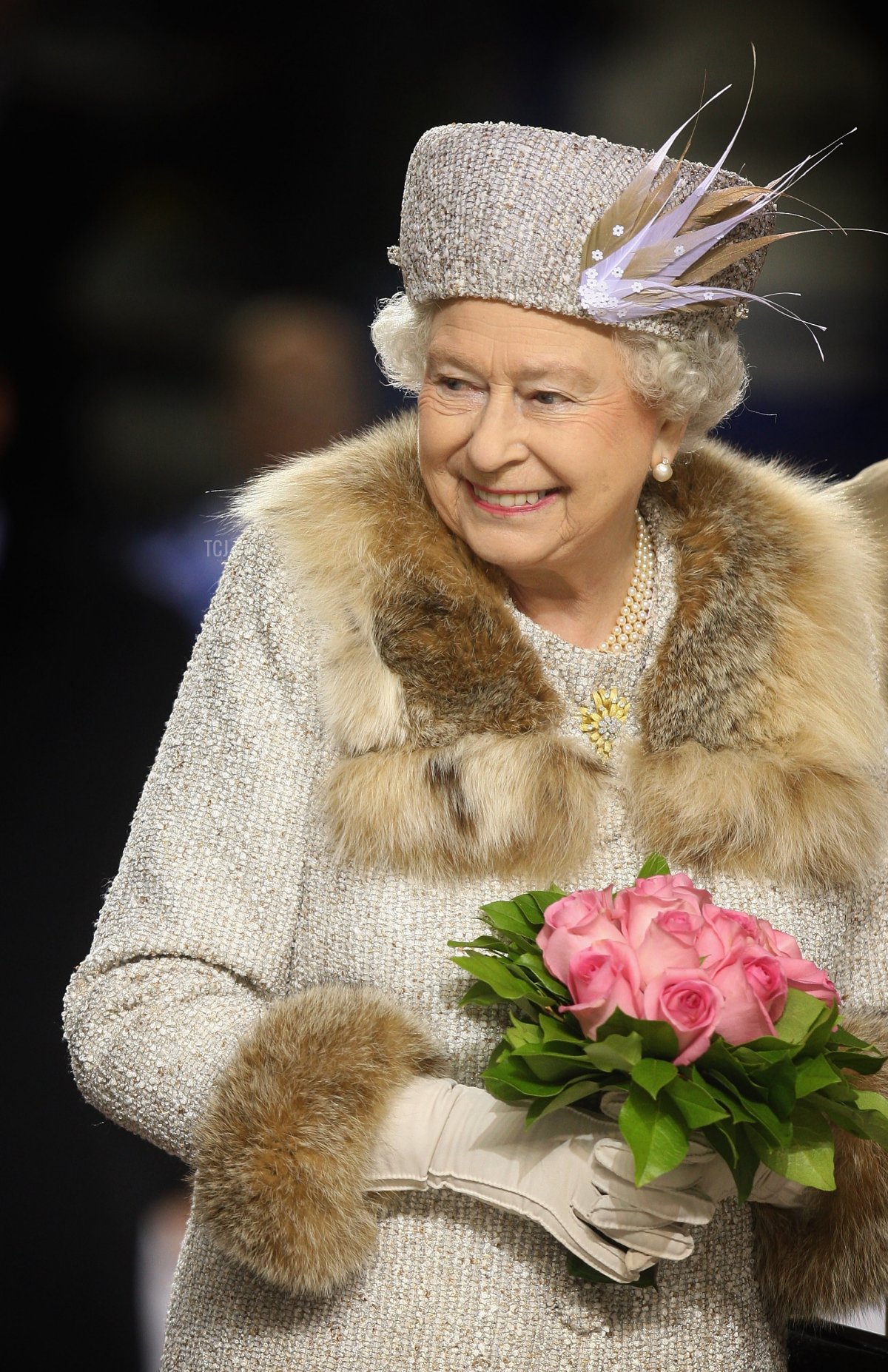 Queen Elizabeth II laughs after throwing in the puck to start an ice hockey match between Aqua City Poprad and Guildford Flames at the ice hockey stadium on the second day of a tour of Slovakia on October 24, 2008 in Bratislava, Slovakia
