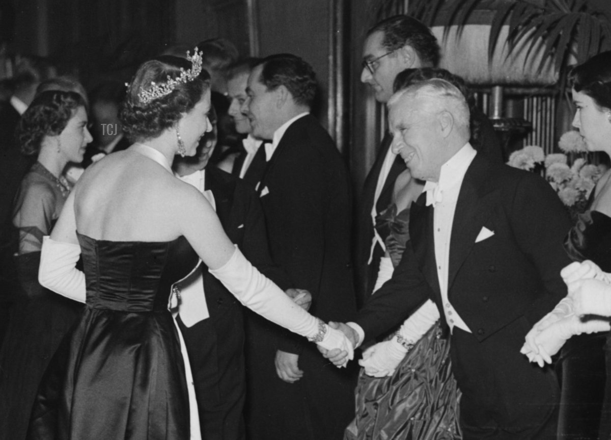 Queen Elizabeth (left, wearing a tiara) shaking hands with actor Charlie Chaplin during a line up after the Royal Film Performance at the Empire, Leicester Square, London, October 27th 1952