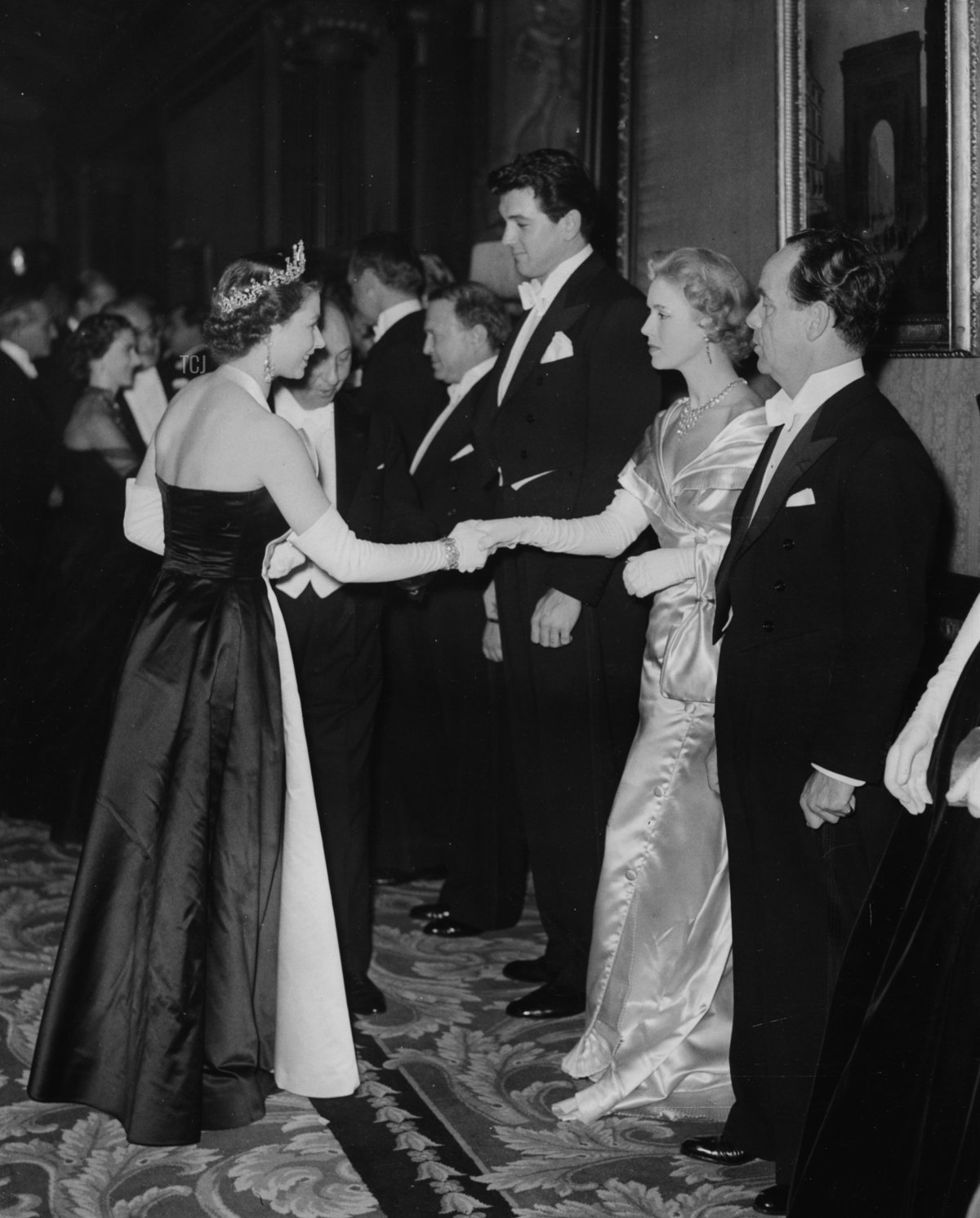 Actress Veronica Hurst, with actor Rock Hudson on her right) being presented to Queen Elizabeth II at the Royal Film Performance in Leicester Square, London, October 27th 1952