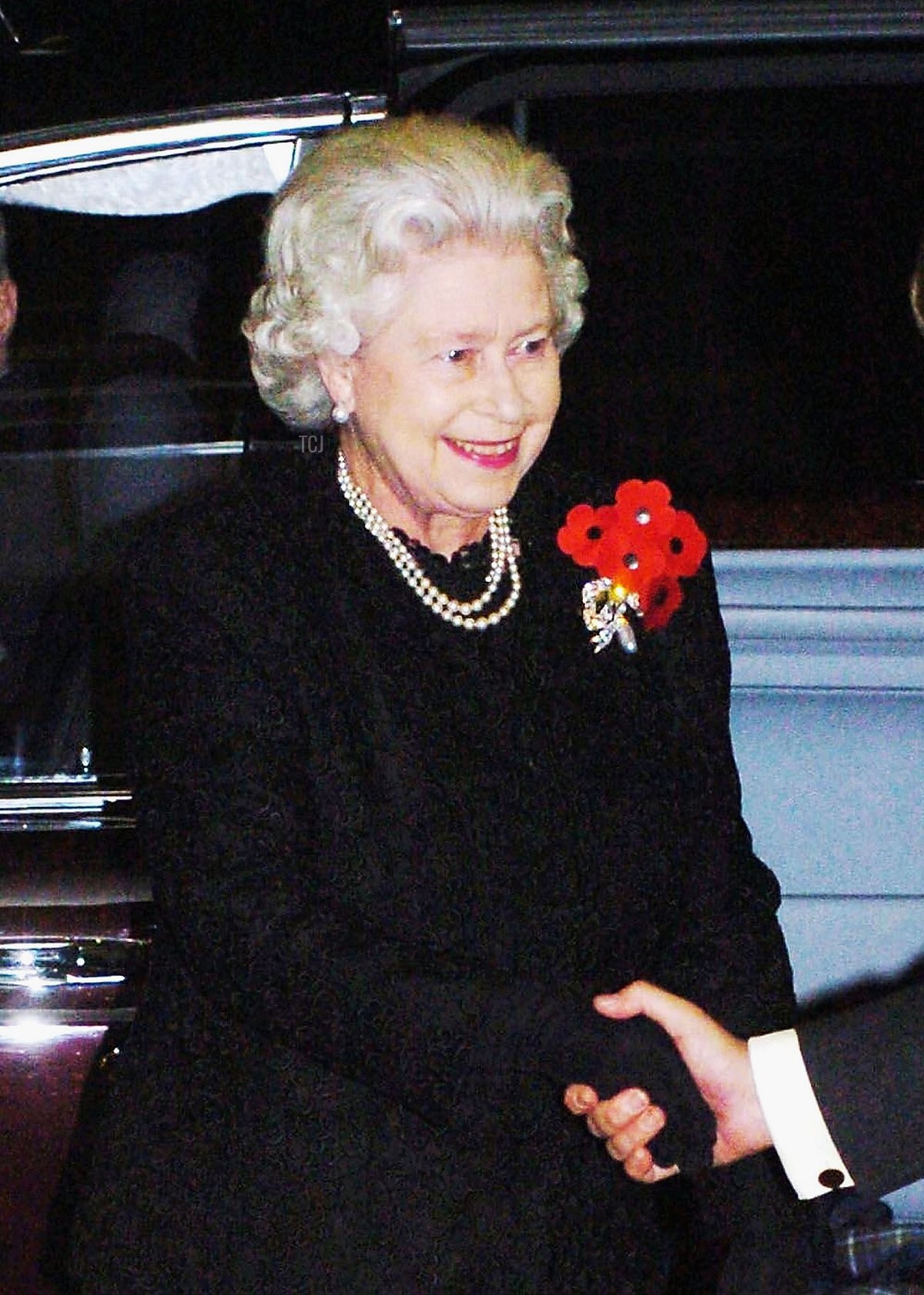 Britain's Queen Elizabeth II is greeted by the President of the Royal Albert Hall Charles Fairweather as she arrives for The Royal British Legion Festival of Remembrance at the Royal Albert Hall on November 13, 2004 in London, England