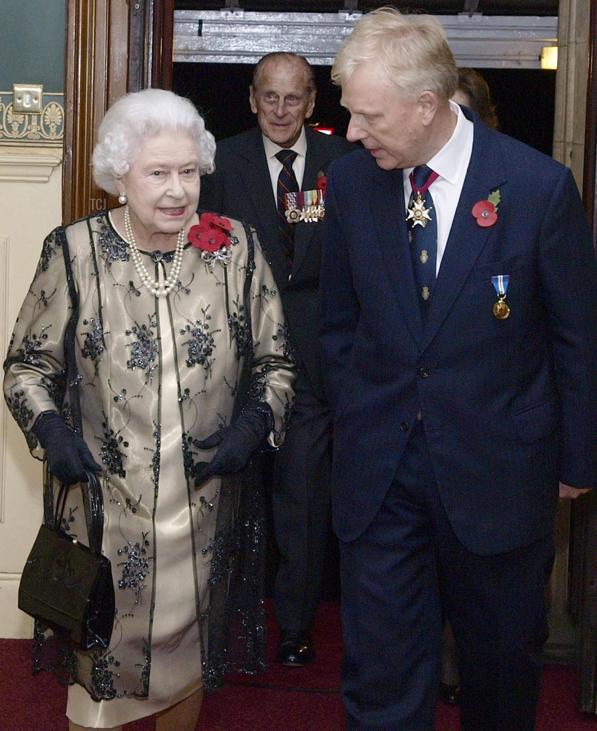 Britain's Queen Elizabeth II (L) is greeted by the President of the Royal British Legion Vice- Admiral Peter Wilkinson (R) as she arrives to attend the annual Royal Festival of Remembrance, at London's Royal Albert Hall, November 10, 2012