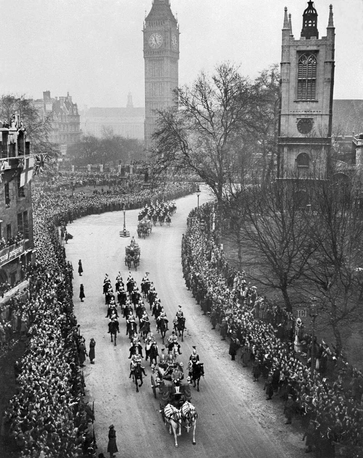 A large crowd salutes the Princess Elizabeth of England and Philip The Duke of Edinburgh as they pass in a horse drawn carriage, during their wedding day, 20 November 1947 in London