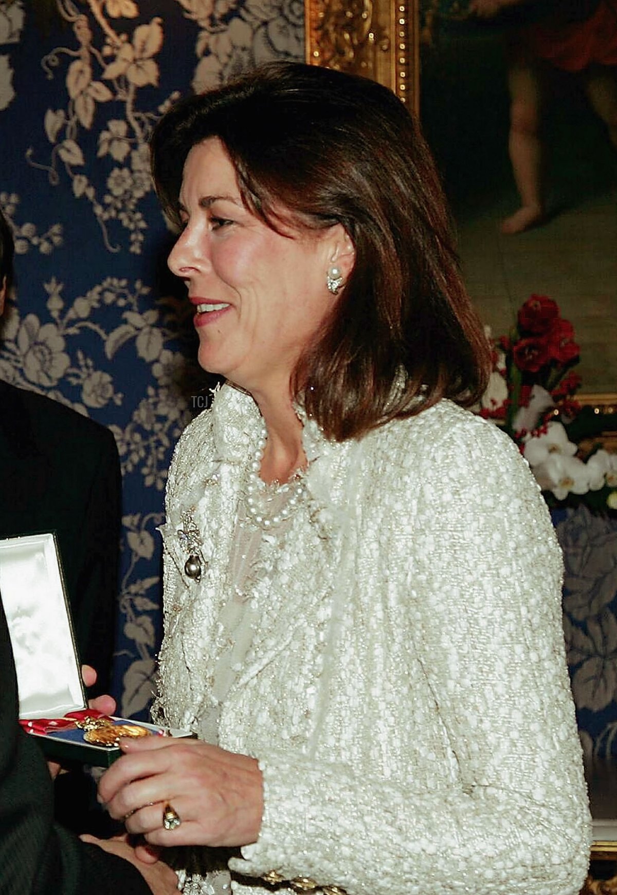 Princess Caroline of Hanover (R) receives the Order of Cultural Merit medal from her brother Prince Albert of Monaco during ceremonies which invested him as ruler of Monaco in Monte Carlo November 17, 2005