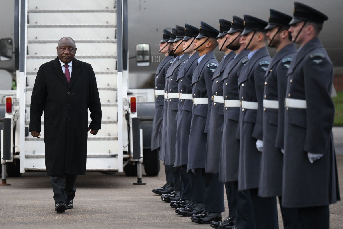South Africa's President Cyril Ramaphosa reviews a guard of honour upon arrival at Stansted airport in London on November 21, 2022