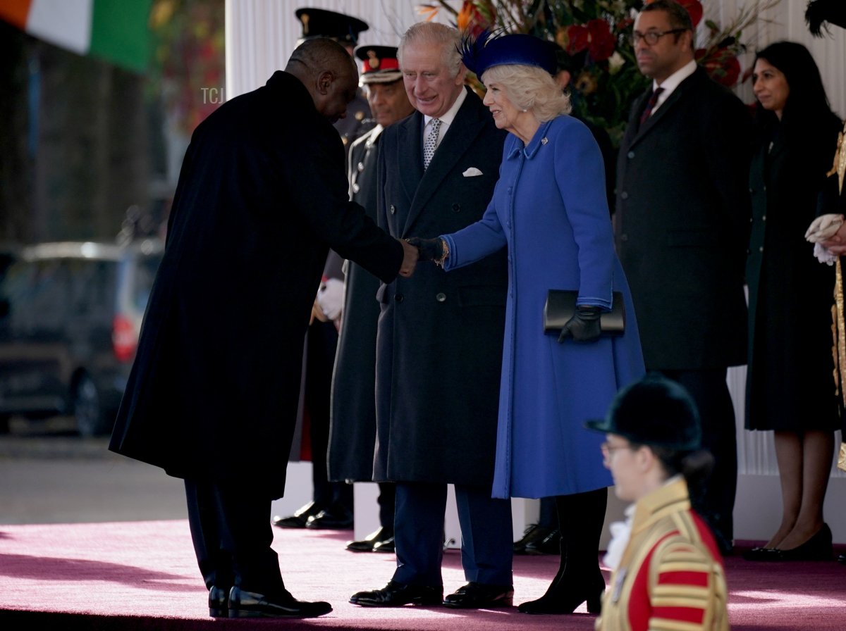President Cyril Ramaphosa of South Africa, shakes hands with the Queen Consort as King Charles III looks on before they inspect a Guard of Honour during the ceremonial welcome for his State Visit to the UK at Horse Guards Parade on November 22, 2022 in London, England