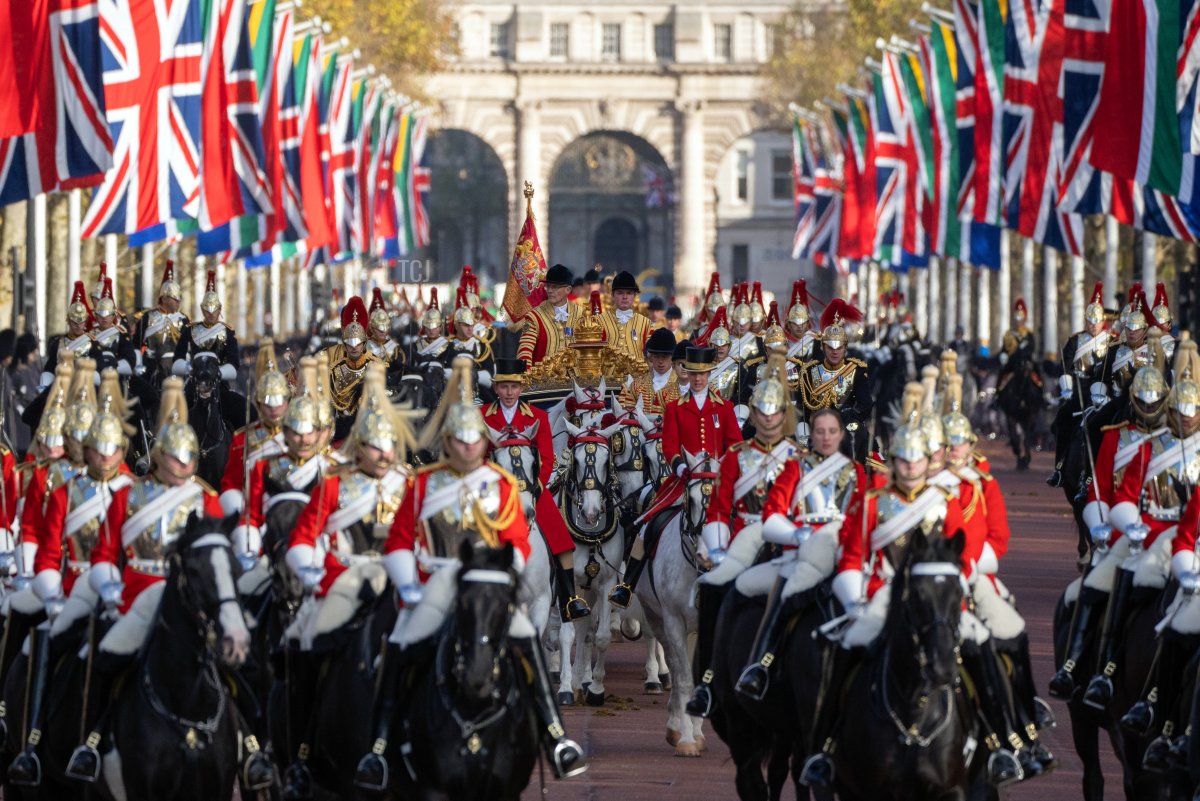 The State Carriage carrying Camilla, Queen Consort, King Charles III and South African President, Cyril Ramaphosa led by a mounted division of the Coldstream Guards makes its way along The Mall towards Buckingham Palace on November 22, 2022 in London, England