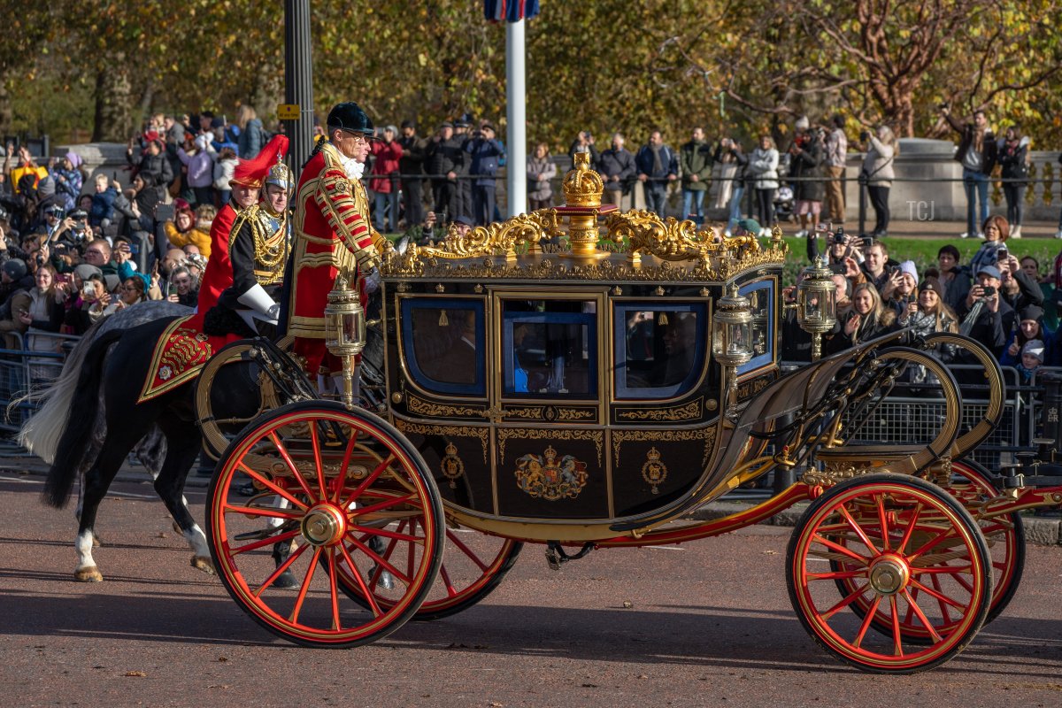 The State Carriage carrying Camilla, Queen Consort, King Charles III and South African President, Cyril Ramaphosa led by a mounted division of the Coldstream Guards makes its way along The Mall towards Buckingham Palace on November 22, 2022 in London, England