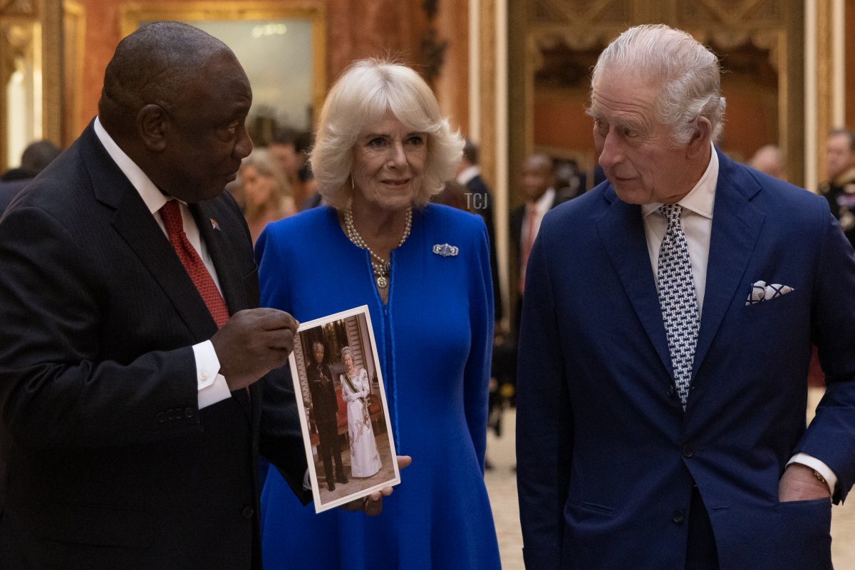 King Charles III and Camilla, Queen Consort show South African President Cyril Ramaphosa items, including a photograph of President Mandela and Queen Elizabeth II, displayed as part of the Royal Collection at Buckingham Palace on November 22, 2022 in London, England