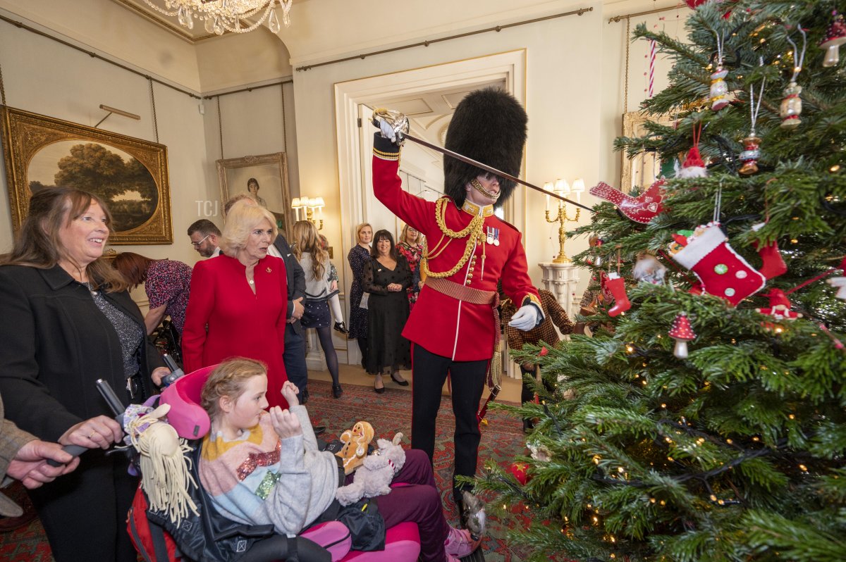 Her Majesty, Camilla, The Queen Consort invites children supported by Helen & Douglas House and Roald Dahl's Marvellous Children's Charity to decorate the Christmas tree and receive a few festive surprises at Clarence House on December 7, 2022 in London, England