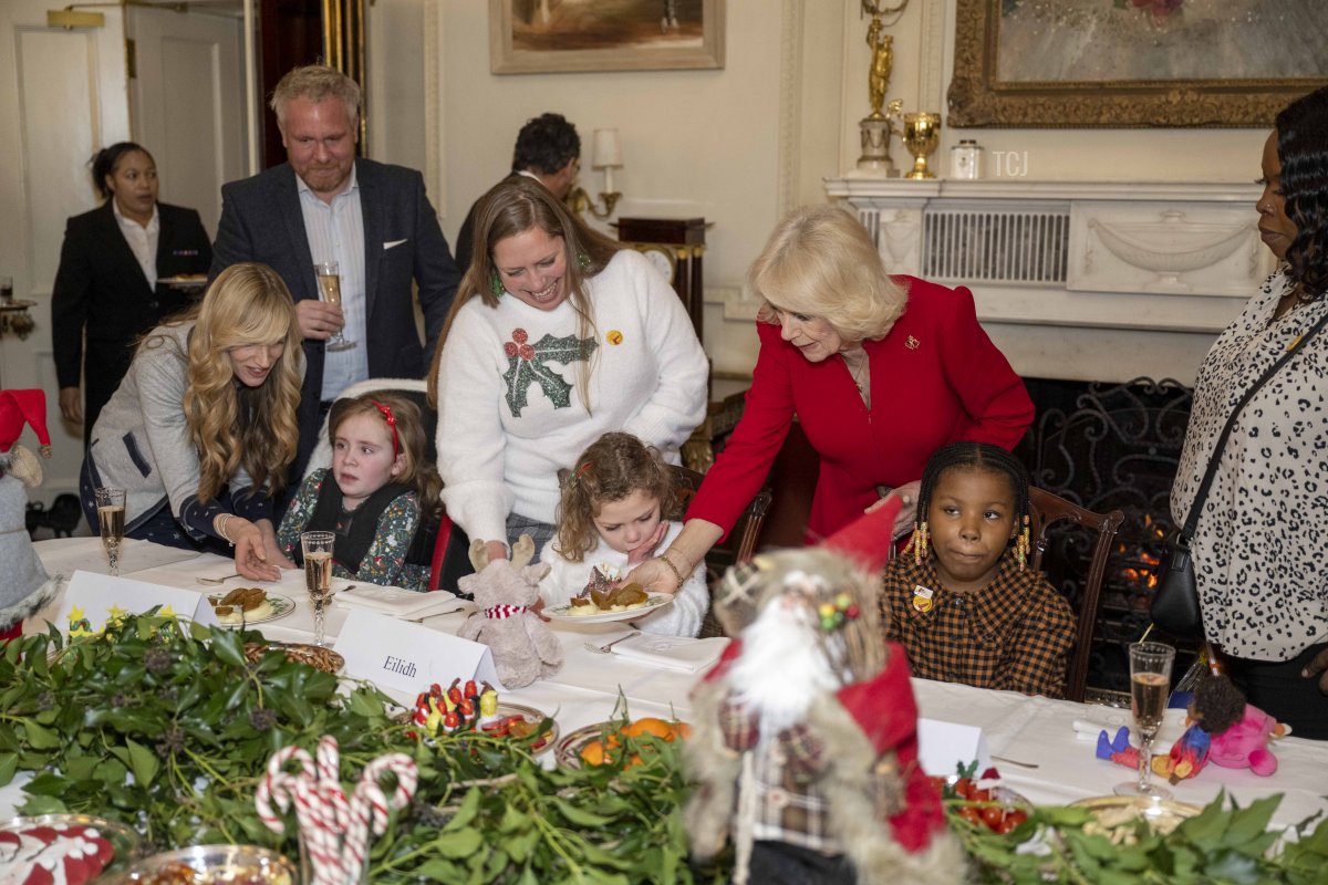 Her Majesty, Camilla, The Queen Consort helps to serve lunch for children at Clarence House on December 7, 2022 in London, England