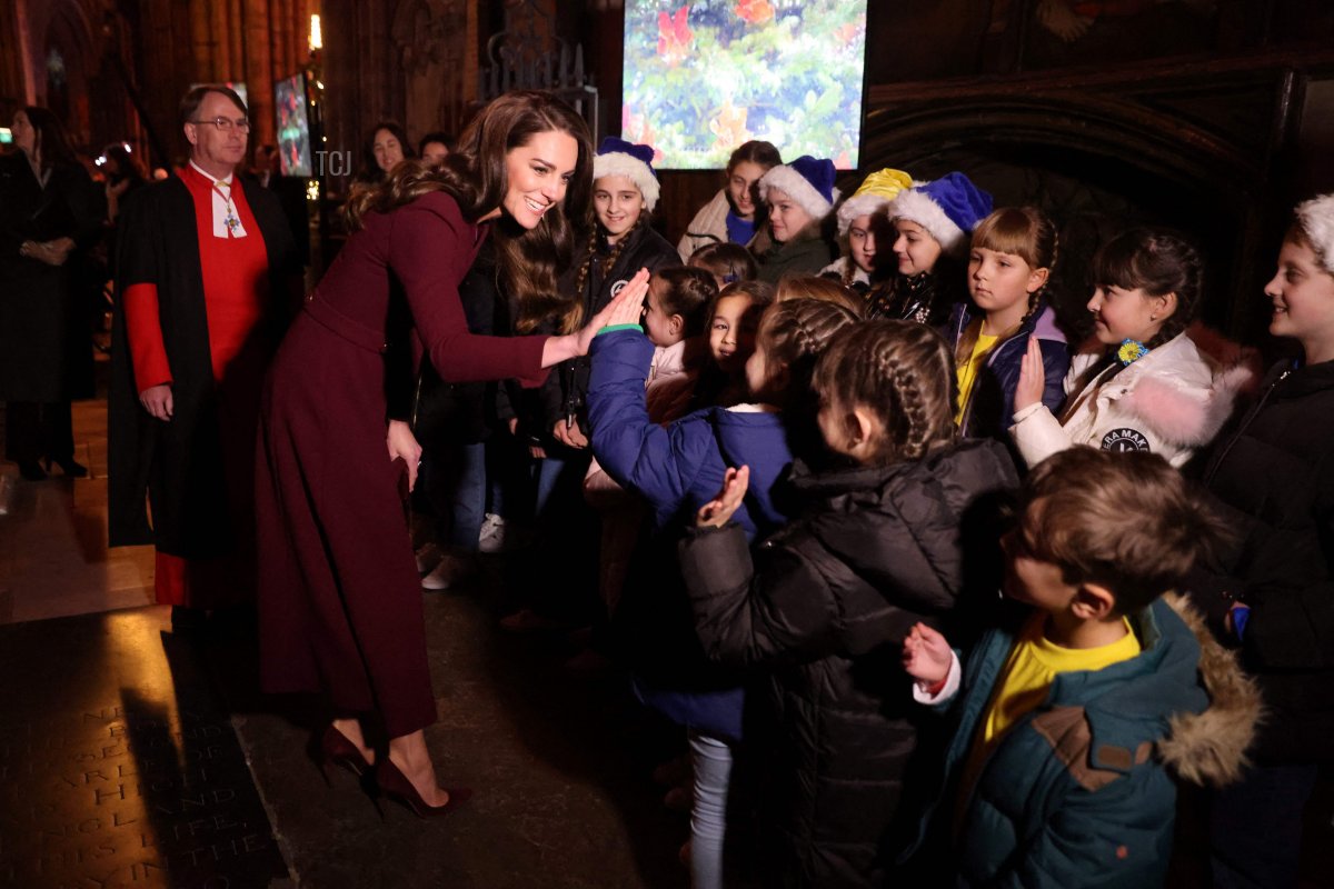Britain's Catherine, Princess of Wales speaks children as she arrives to attend the "Together At Christmas Carol Service" at Westminster Abbey, in London, on December 15, 2022