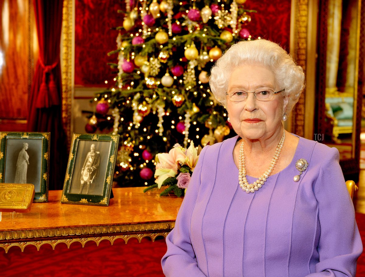 Britain's Queen Elizabeth II poses in the State Dining Room of Buckingham Palace after recording her Christmas Day television broadcast to the Commonwealth on December 10, 2014 in London