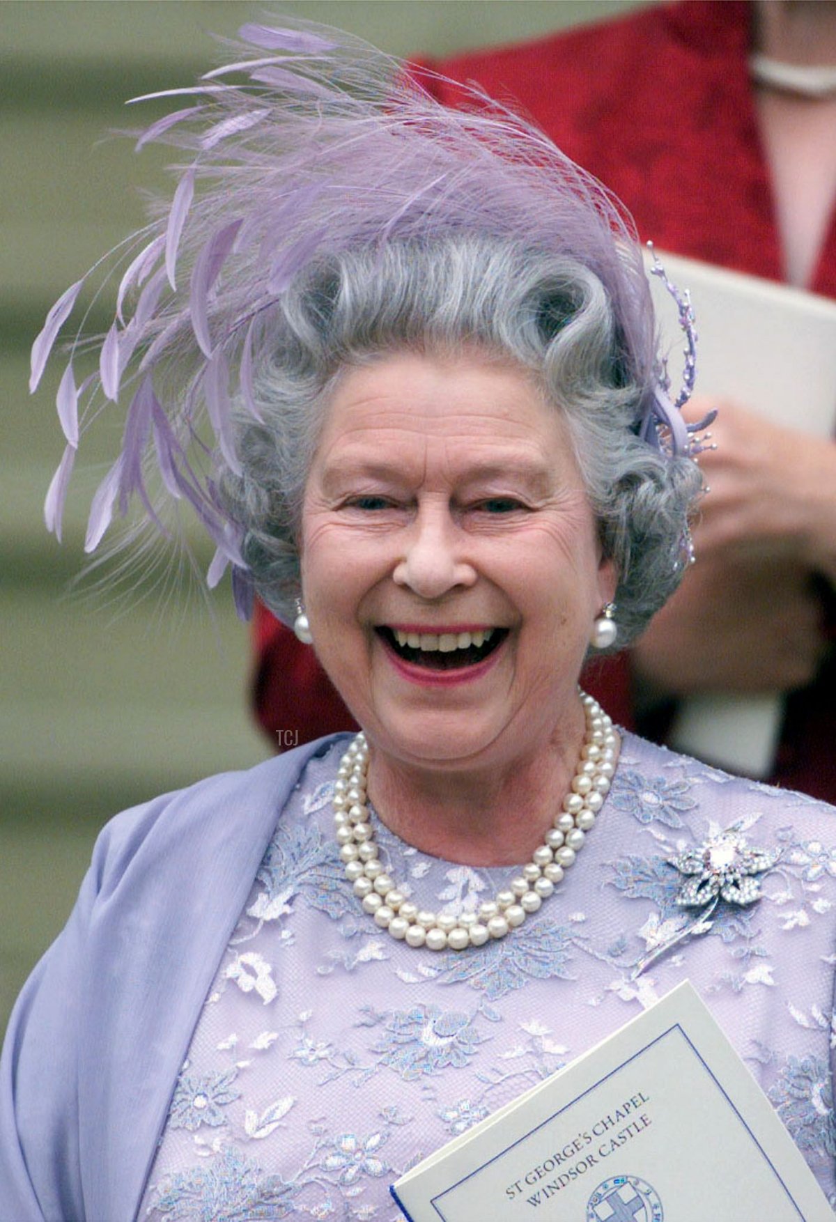 Queen Elizabeth II of the United Kingdom laughs as she leaves St. George's Chapel in Windsor Castle after the wedding of her son, Prince Edward, and Sophie Rhys-Jones, 19 June 1999 (IAN WALDIE/AFP via Getty Images)