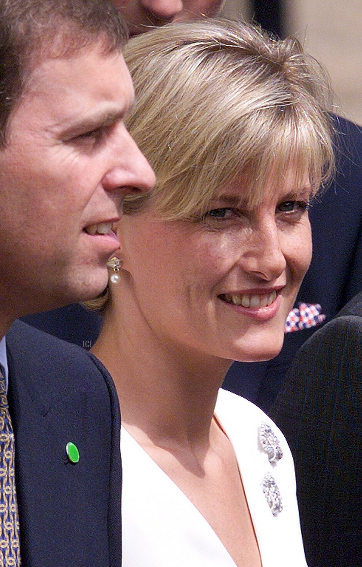 Recently wed Sophie Rhys-Jones, Countess of Wessex, stands beside her brother-in-law, Prince Andrew, during a family photograph on the occasion of the Queen Mother's 99th birthday at her London residence, Clarence House, 4 August 1999 (JONATHAN UTZ/AFP via Getty Images)