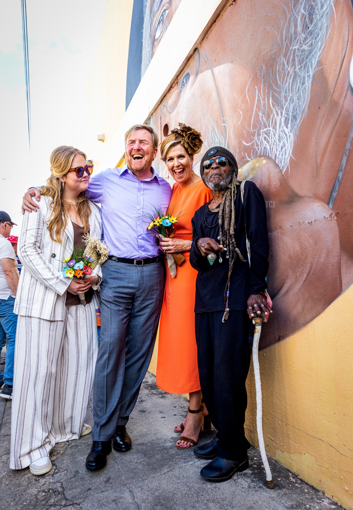 Princess Amalia, King Willem-Alexander, and Queen Maxima of The Netherlands pose with a local artist during a visit to the neighborhood of San Nicolas on day three of the Dutch royal family's tour of the Dutch Caribbean Islands on January 30, 2023 in Aruba (Patrick van Katwijk/Getty Images)