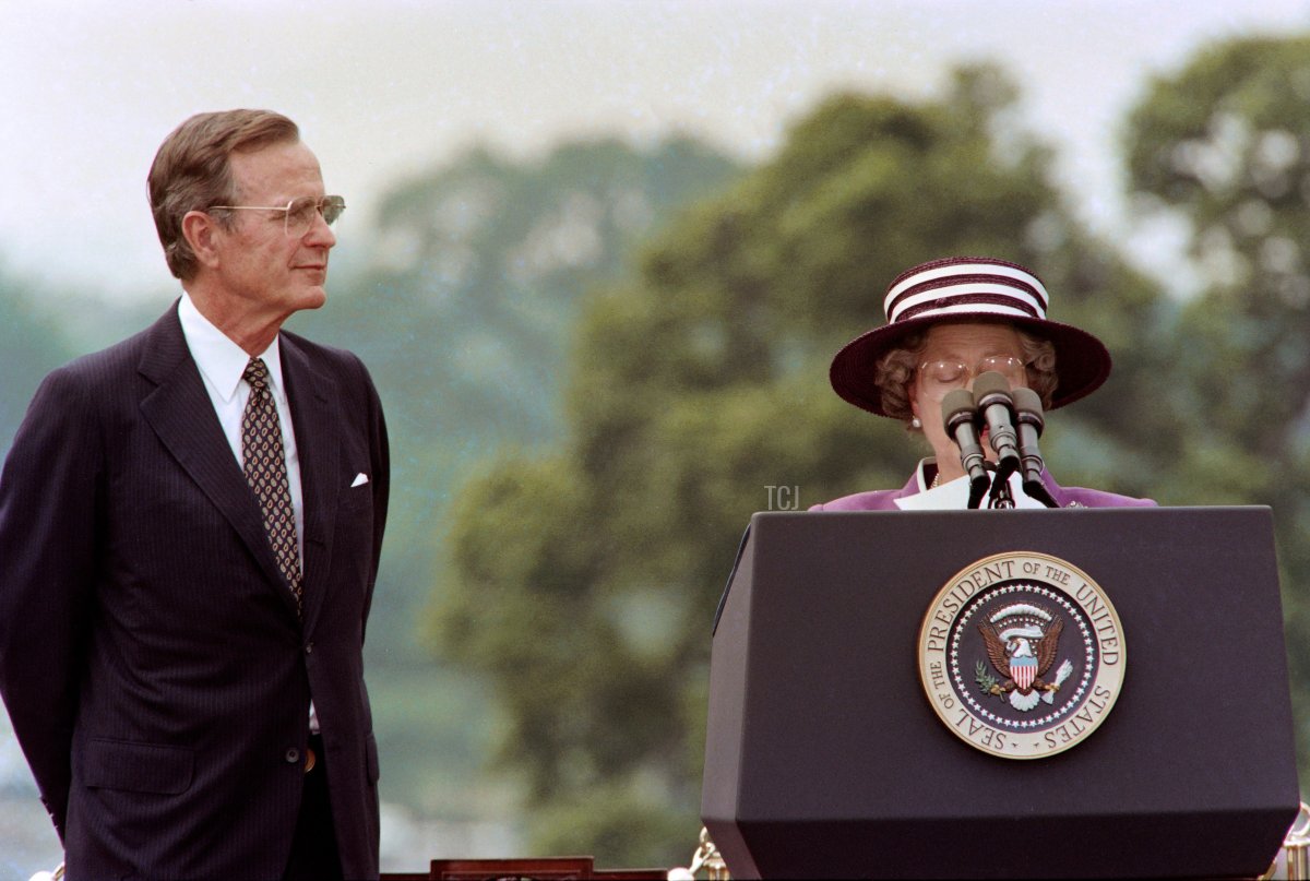 US President George Bush listens as Britain's Queen Elizabeth II reads her brief remarks to a crowd gathered at the White House in Washington to welcome her and Prince Philip to the United States for a 10-day state visit on May 14, 1991 (JEROME DELAY/AFP via Getty Images)