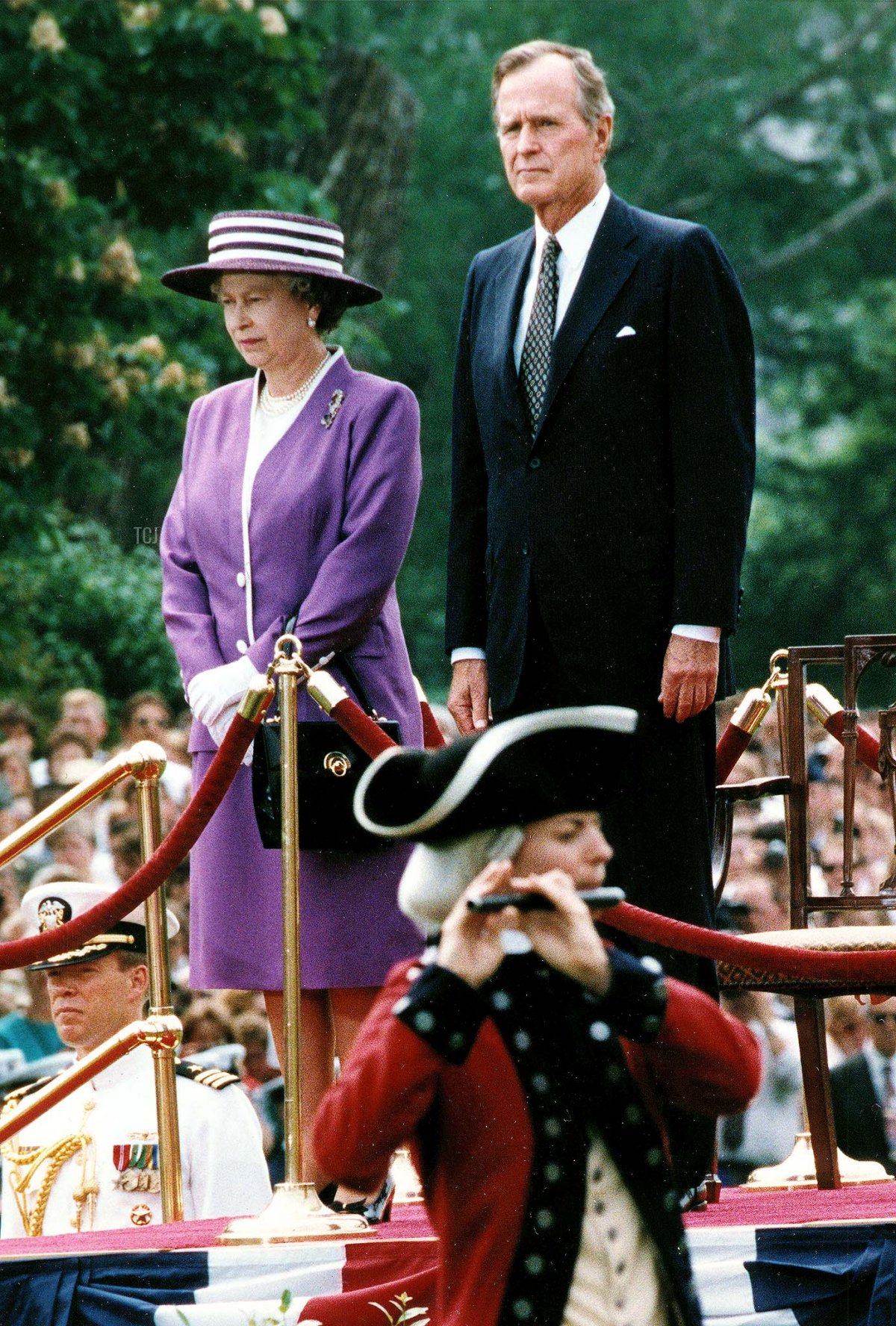 Queen Elizabeth II and US President George Bush watch as the 3rd US Infantry passes in review during a welcoming ceremony on May 14, 1991 at the White House, in Washington, D.C. (J. DAVID AKE/AFP via Getty Images)