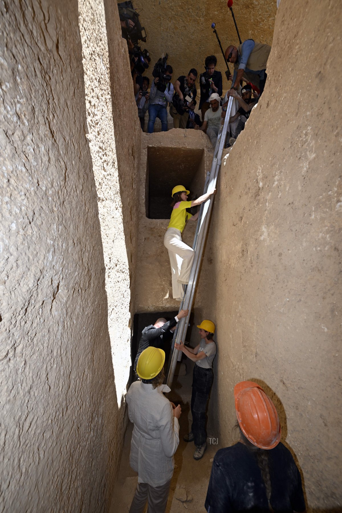 The Duchess of Brabant descends from a ladder during a visit to the excavation site of Dayr-al-Barsha in Egypt, March 16, 2023 (ERIC LALMAND/BELGA MAG/AFP via Getty Images)
