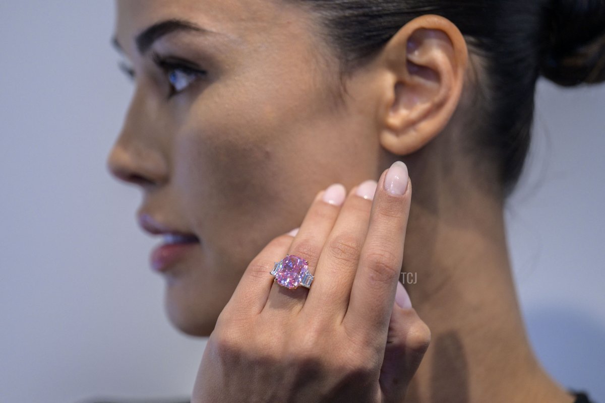 A model wears a 10.57 carat vivid pink diamond, with an estimated value of more than $35 million US dollars, during a press preview at Sotheby's in New York City on March 27, 2023 (ANGELA WEISS/AFP via Getty Images)