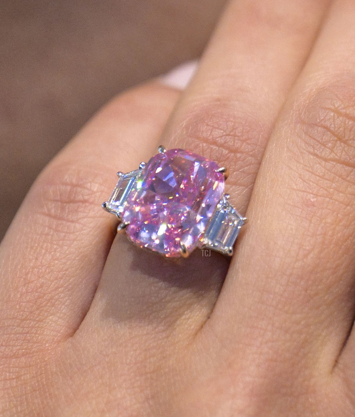 A model wears a 10.57 carat vivid pink diamond, with an estimated value of more than $35 million US dollars, during a press preview at Sotheby's in New York City on March 27, 2023 (ANGELA WEISS/AFP via Getty Images)