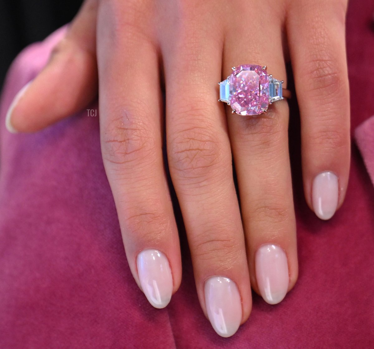 A model wears a 10.57 carat vivid pink diamond, with an estimated value of more than $35 million US dollars, during a press preview at Sotheby's in New York City on March 27, 2023 (ANGELA WEISS/AFP via Getty Images)