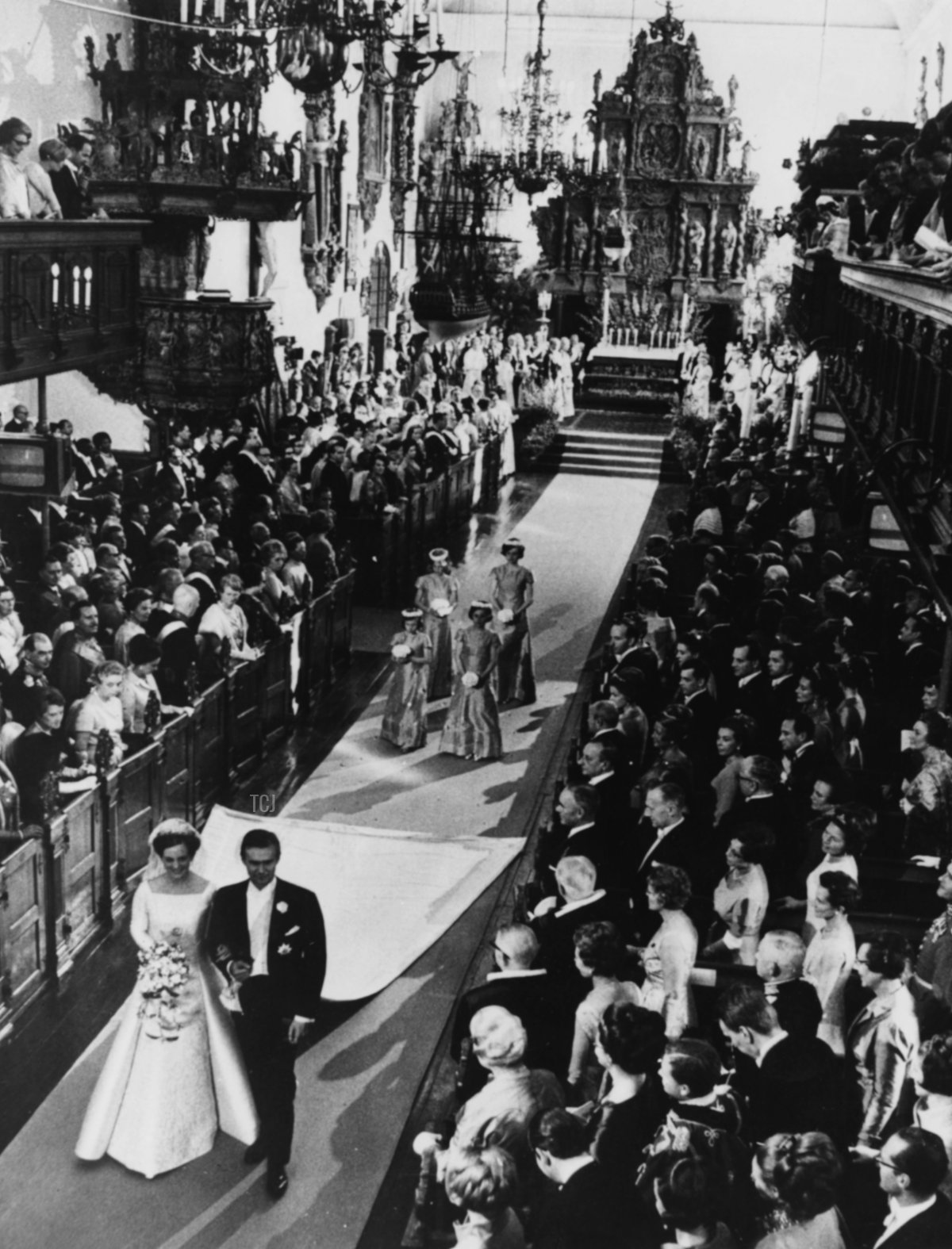 Crown Princess Margrethe of Denmark and her new husband, Count Henri de Laborde de Monpezat, walk past the guests as they leave the Holmen Church following their wedding ceremony in Copenhagen on June 10, 1967 (Keystone/Hulton Archive/Getty Images)
