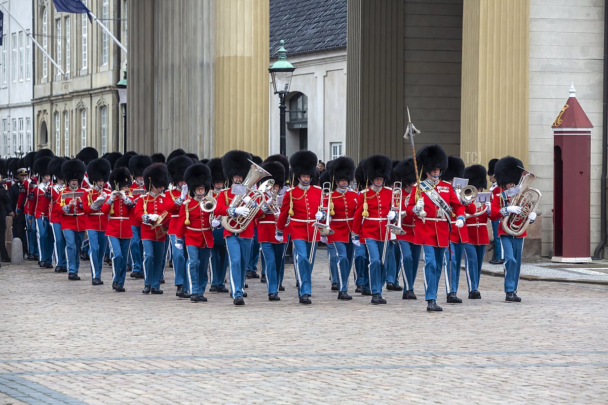 The Queen's Guard parade in their red gala uniforms before Queen Margrethe of Denmark appears on the balconies of Christian IX's Palace at Amalienborg Palace on April 16, 2023 in Copenhagen, Denmark (Ole Jensen/Getty Images)